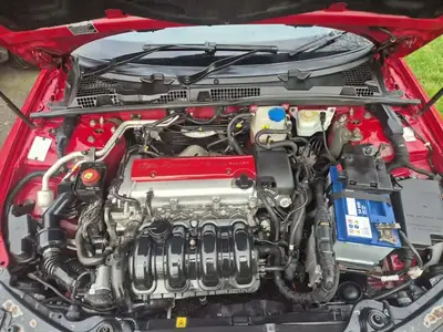 Dirty engine bay before steam cleaning treatment