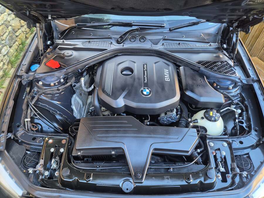 Engine bay steam clean in progress with Karcher equipment
