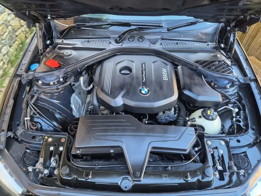 Engine bay steam clean in progress with Karcher equipment
